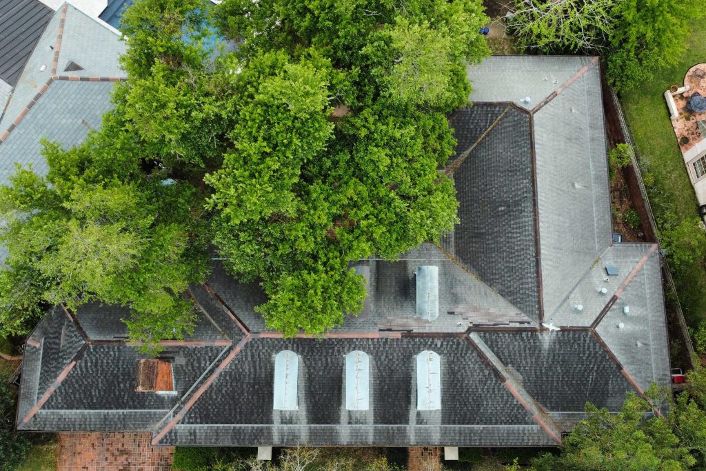 Aging residential roof with visible shingle deterioration and moss growth in the West Georgia area.